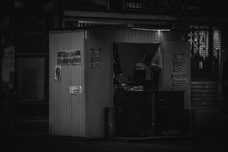 a portable fridge sitting outside at night with the dark city lights lit up behind it