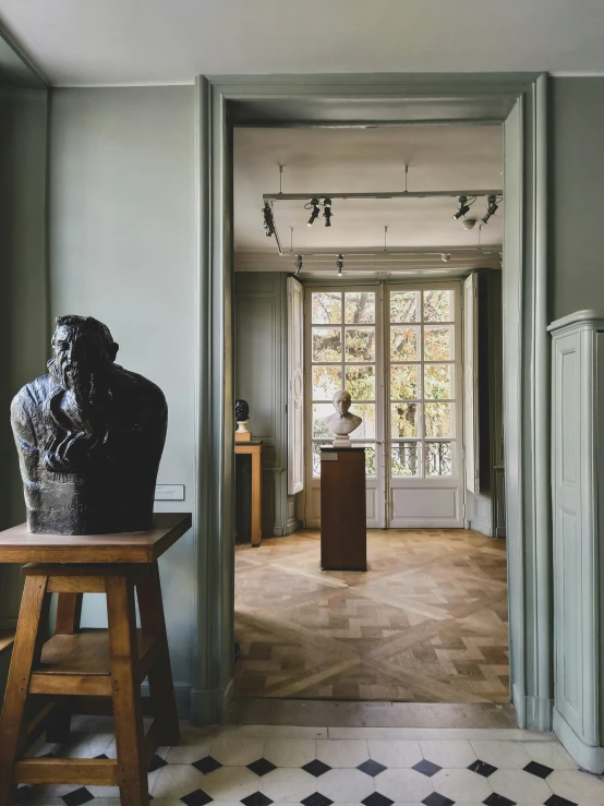 a view of a room with a statue next to a window