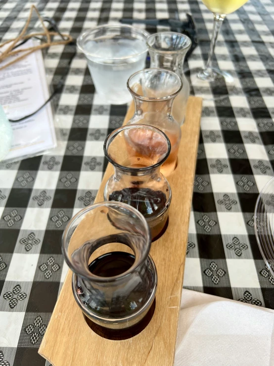 glasses of wine are sitting on the serving board