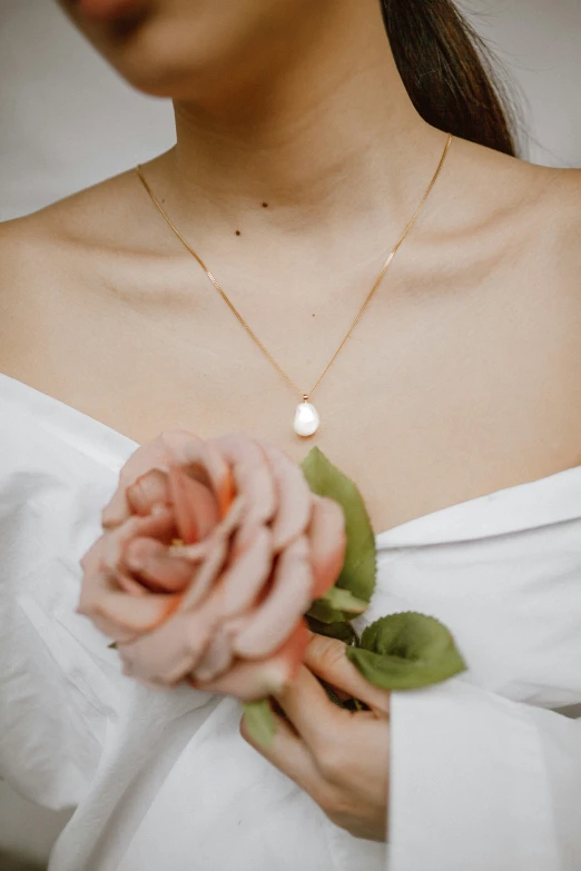 a woman holds a flower in her hand