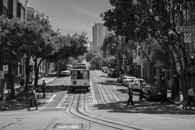 an elevated trolley traveling along a city street