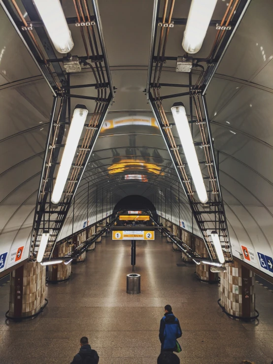 two people waiting for their luggage at the train station