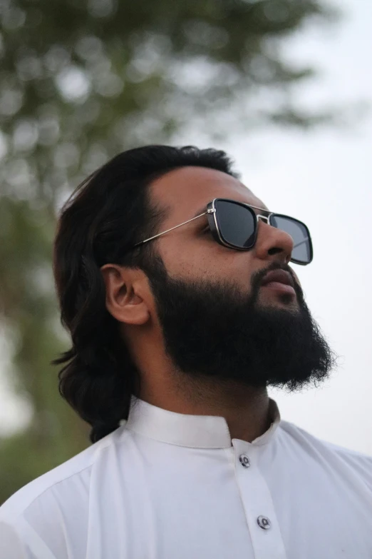 a man with long hair and a beard wearing sunglasses