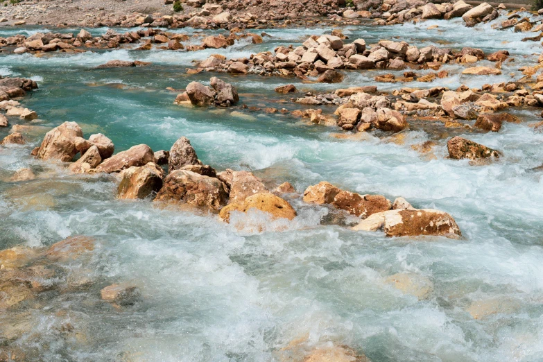 several large rocks in a mountain river