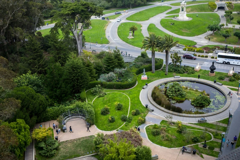 several people standing around the circular fountain