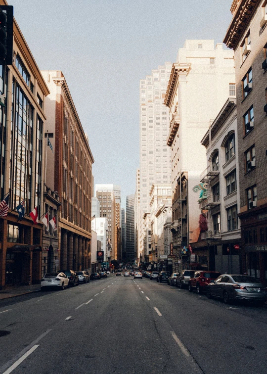 a wide empty city street with buildings on either side