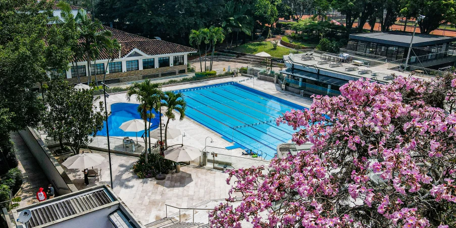 an overhead view of a pool next to a park