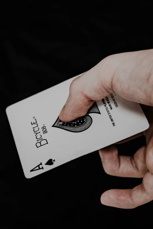 a person is holding up a deck of playing cards