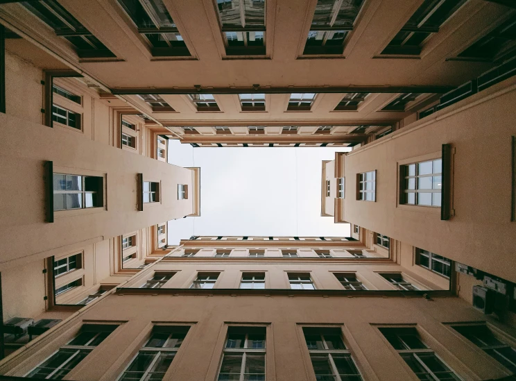 a perspective looking up at the floor through tall buildings