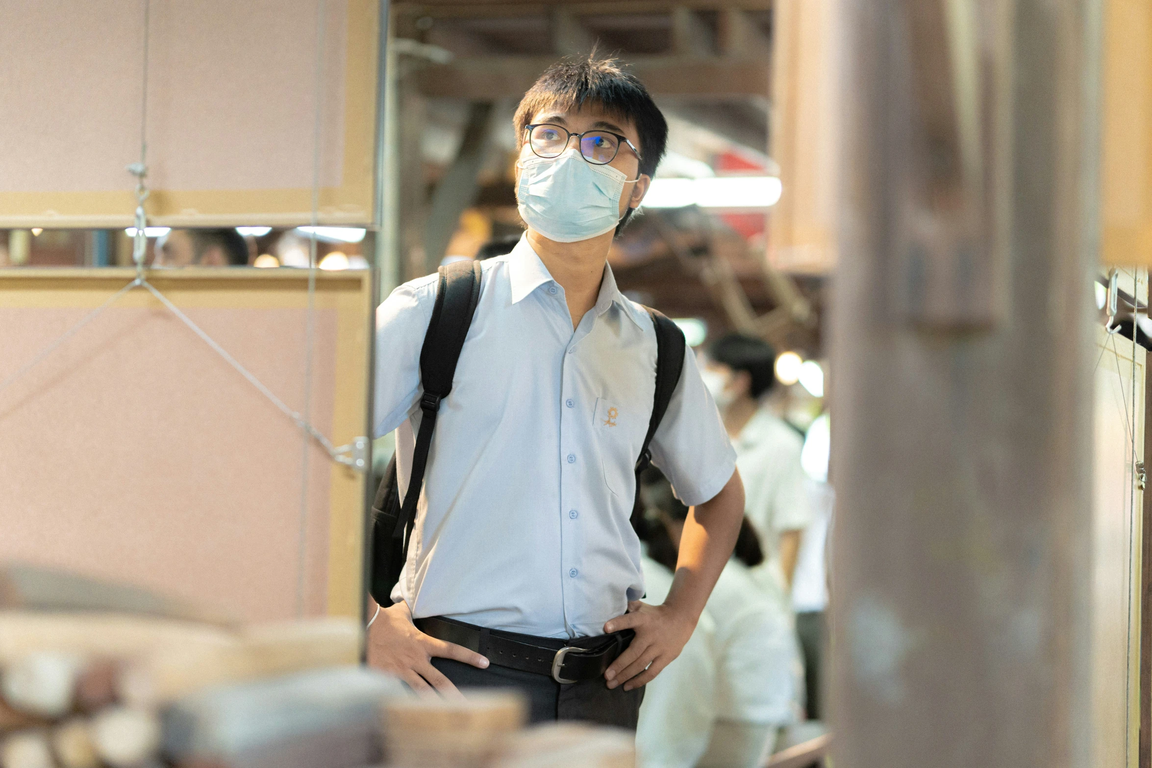 a man with a backpack, shirt and mask on