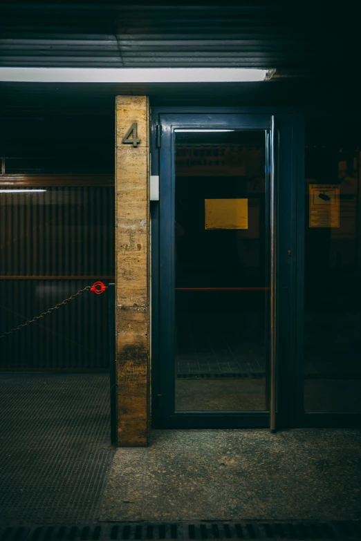 a sign in front of an open door on the outside of a building