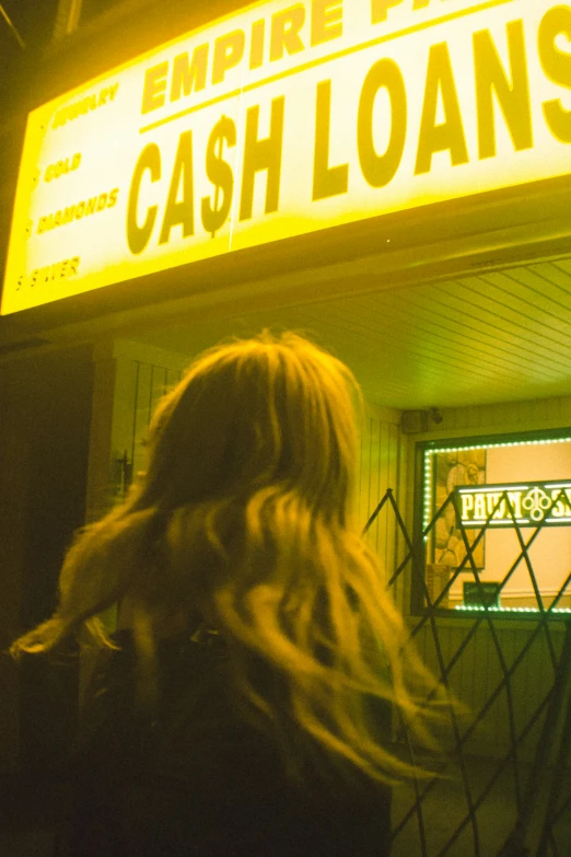 a girl in a jacket and some neon lights