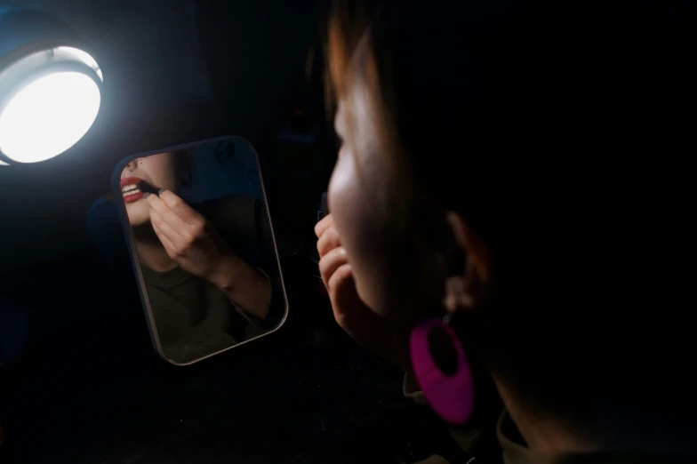 a woman is shown in front of the mirror brushing her teeth