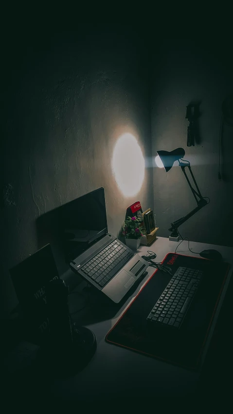 a laptop computer sitting on a desk in the corner of a room