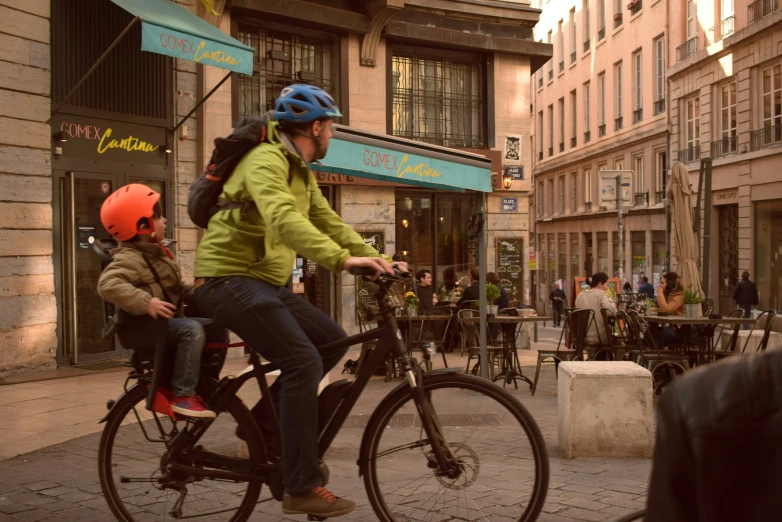 a couple of people are riding bikes down the street