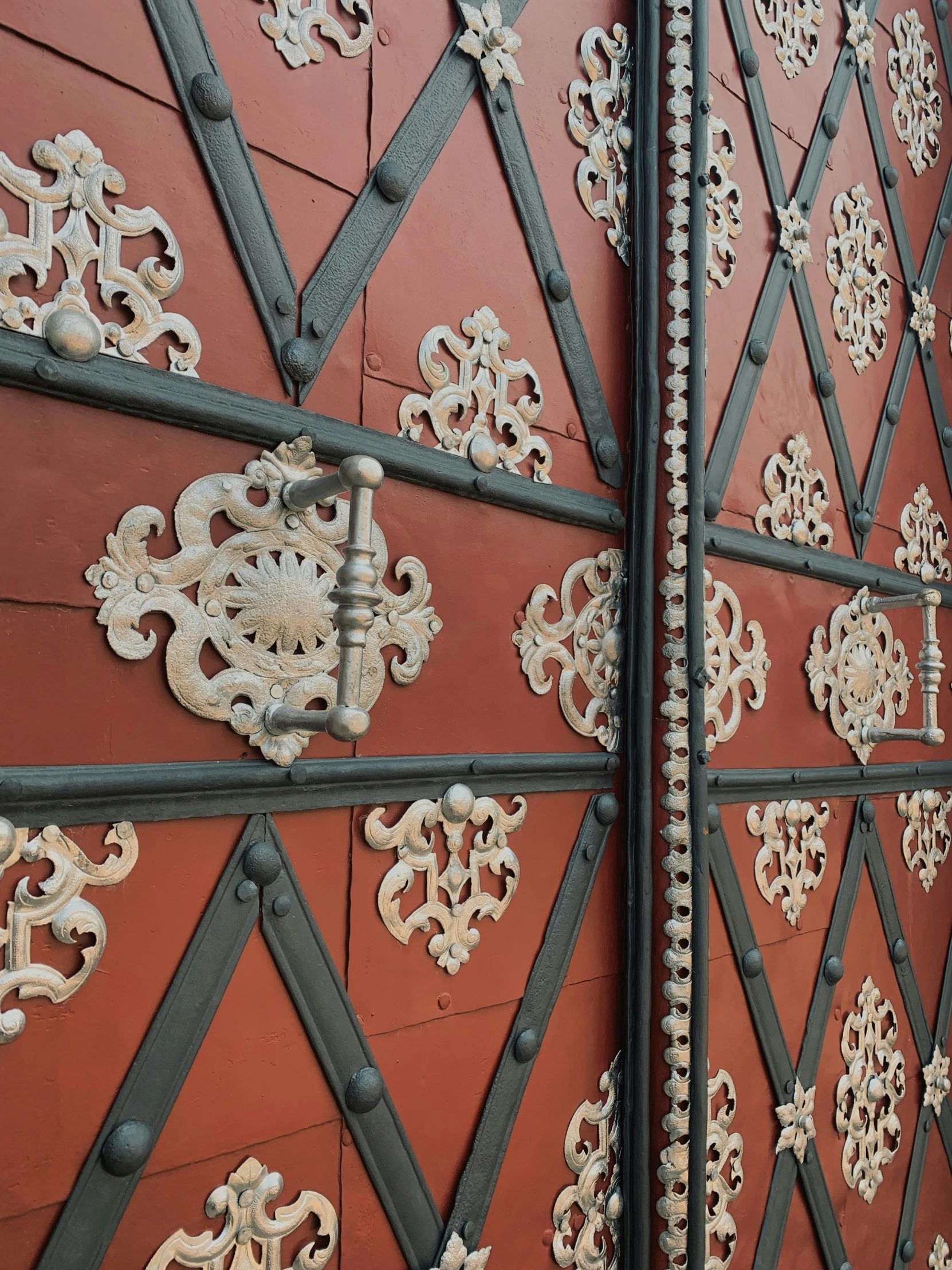 decorative patterns and rivets on the wall of a building