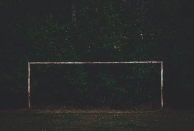 a soccer goal on a field in the dark