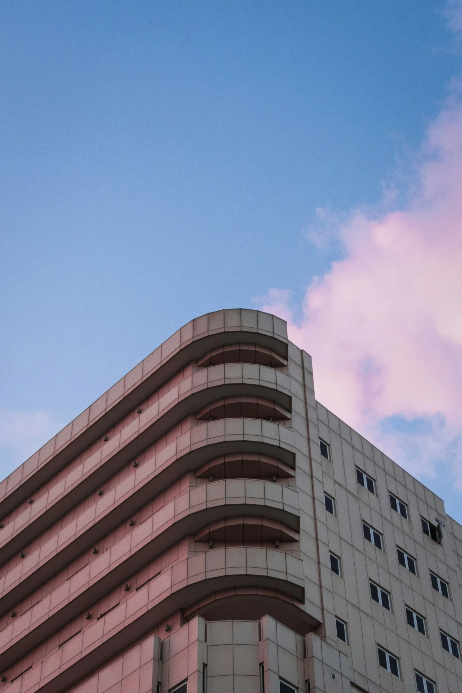 a pink building with red walls against a blue sky