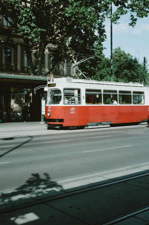 an old tram car moving on the road