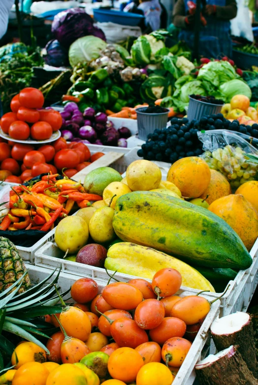 a display at a fruit stand with assorted fruits and vegetables