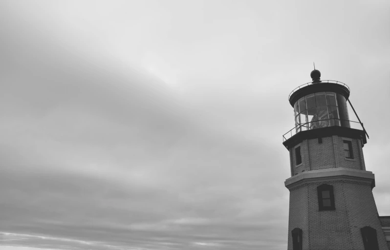 a lighthouse on the beach near a large body of water