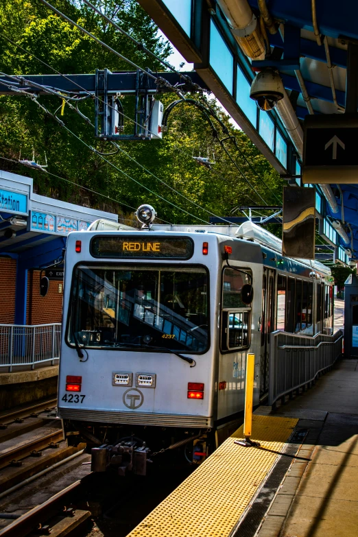 an electric train waiting at the end of the platform