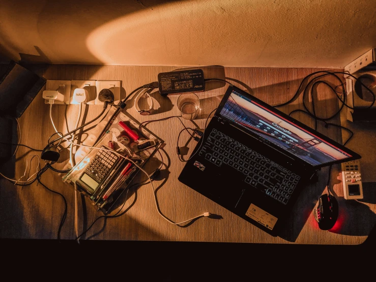 a table with electrical devices on it and a laptop next to it