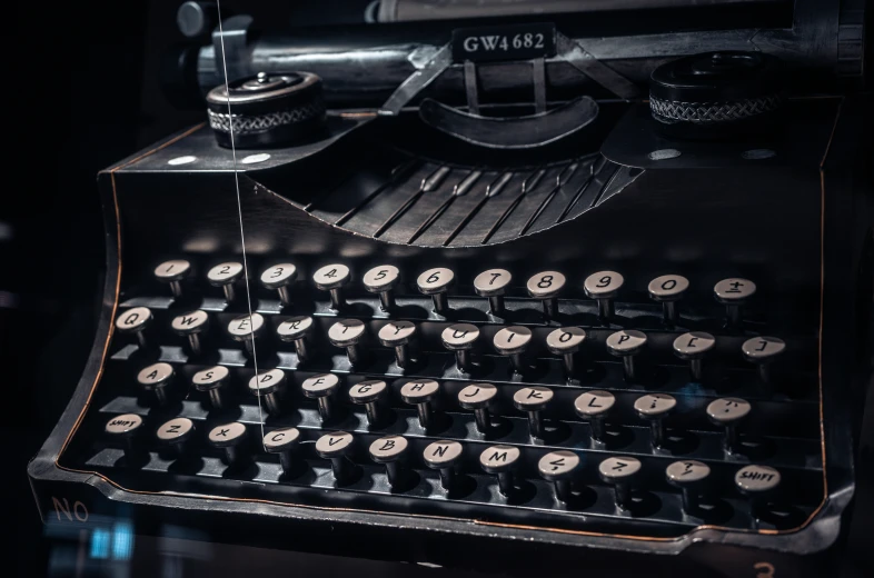 an old style typewriter and desk in a darkened room