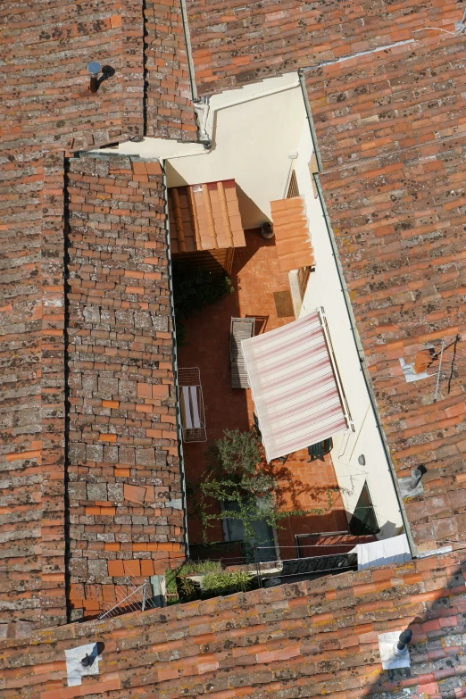 an elevated s shows the roof of a brick building with two tables on top