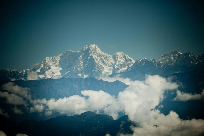 some snowy mountains covered in white clouds