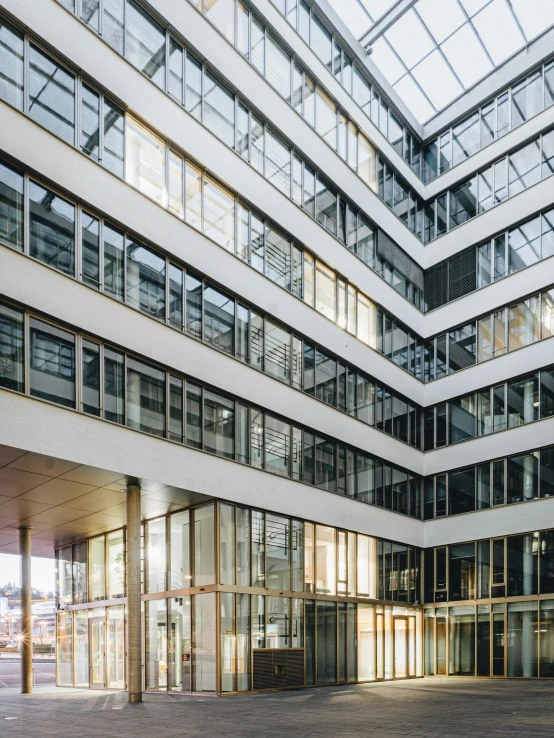 an empty office building with the glass walkway to it