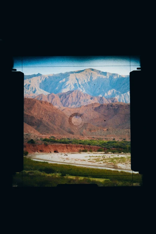 this is the view from inside a building looking at mountains