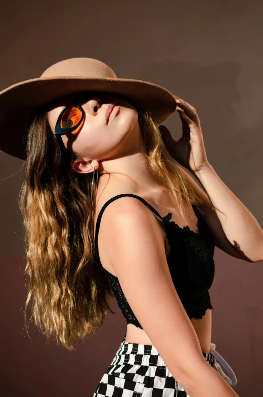 woman with long hair wearing hat and sunglasses