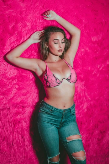 a girl lying on pink rug in a top