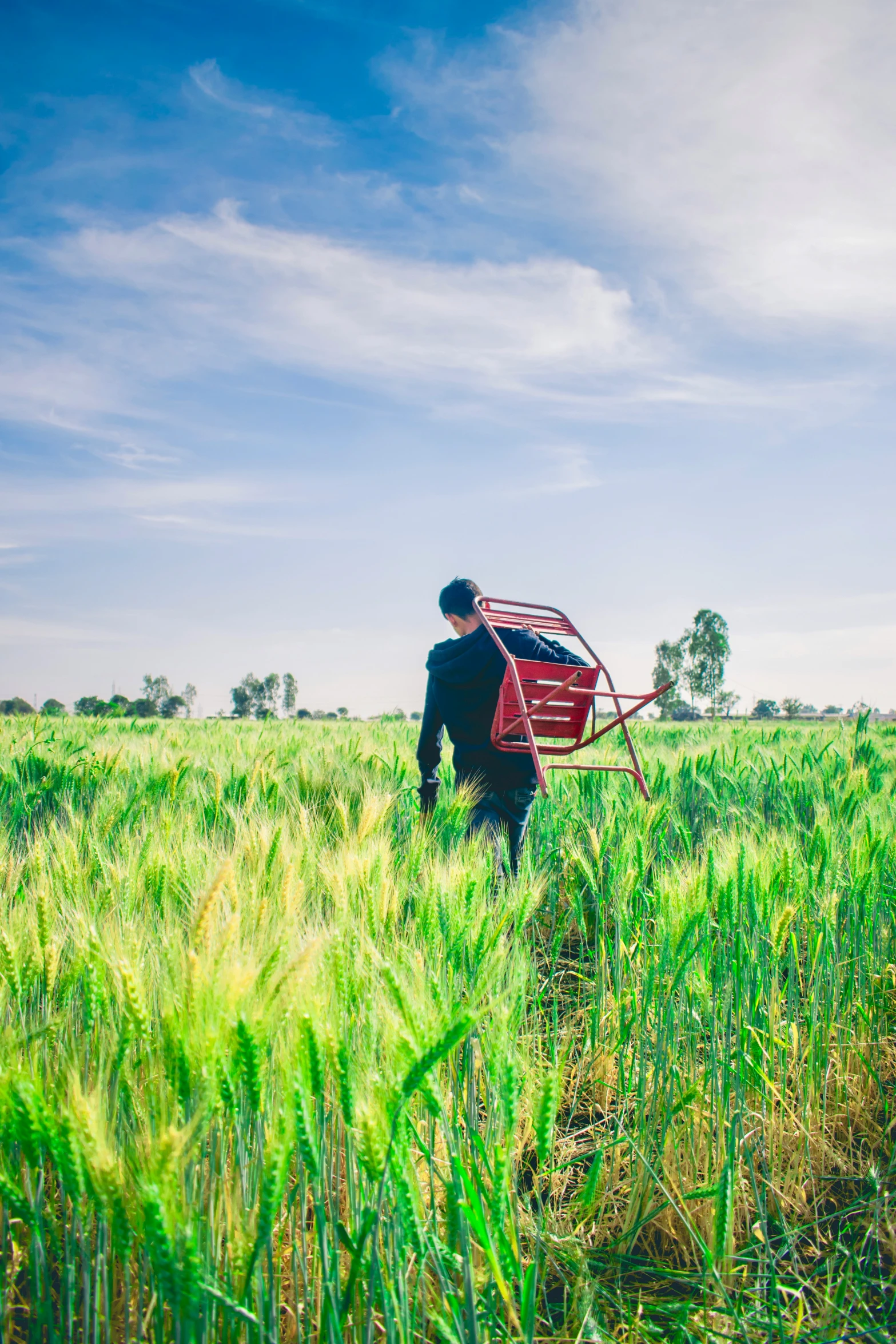 a man that is standing in the grass with a basket