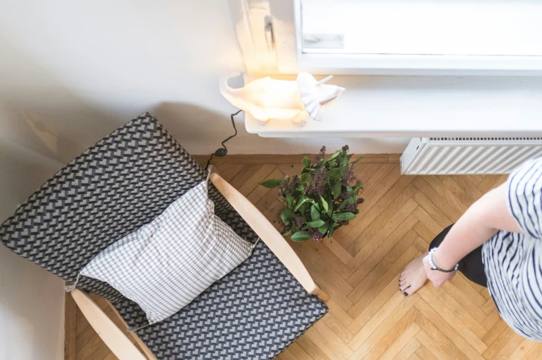 a chair that is in the floor next to pillows