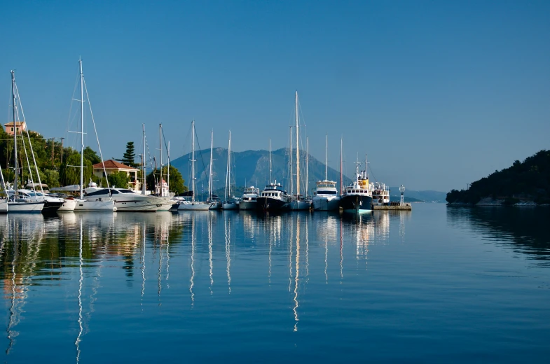 a group of sailboats on the water