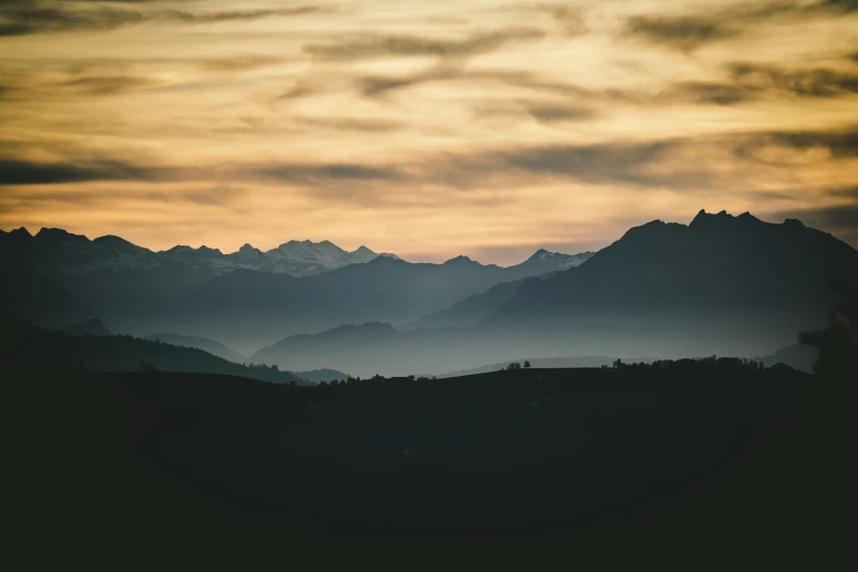 a sky view of mountains during the sunset