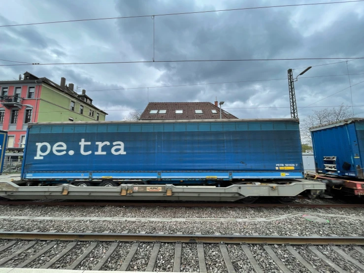 train cars are parked on the tracks next to some buildings