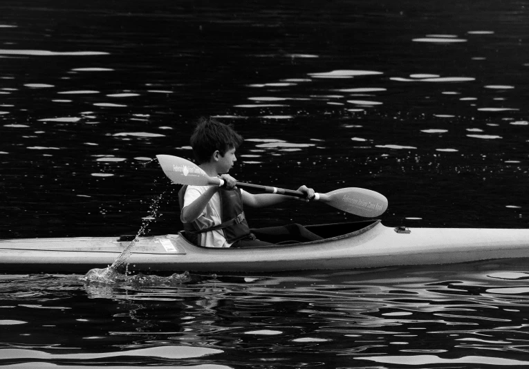 a man in the water on a canoe