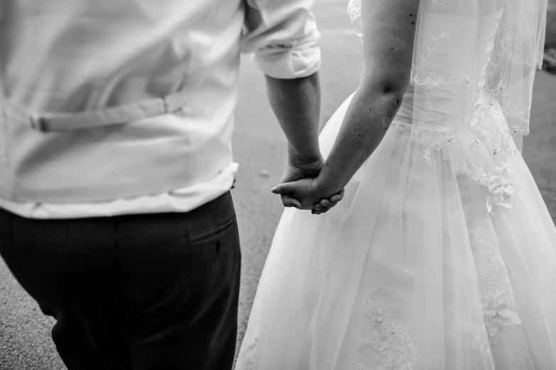 the newlywed couple is holding hands on their wedding day