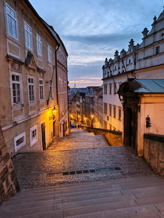 an empty cobblestone street that is lined with buildings