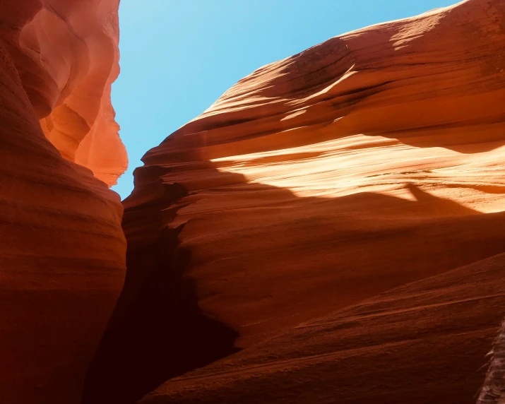 a large cliff that is sitting above some sand