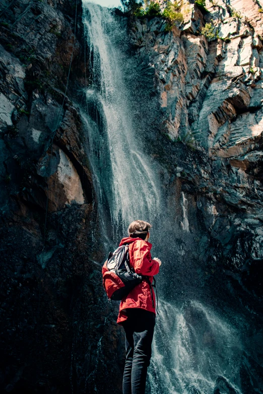 a person standing in front of a waterfall