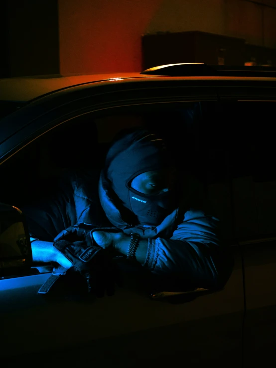 a person sitting in a car using a cell phone