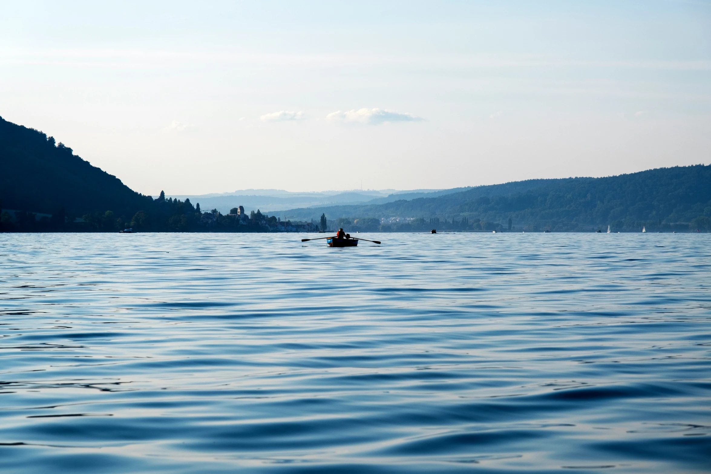 a person rowing a small boat on the water