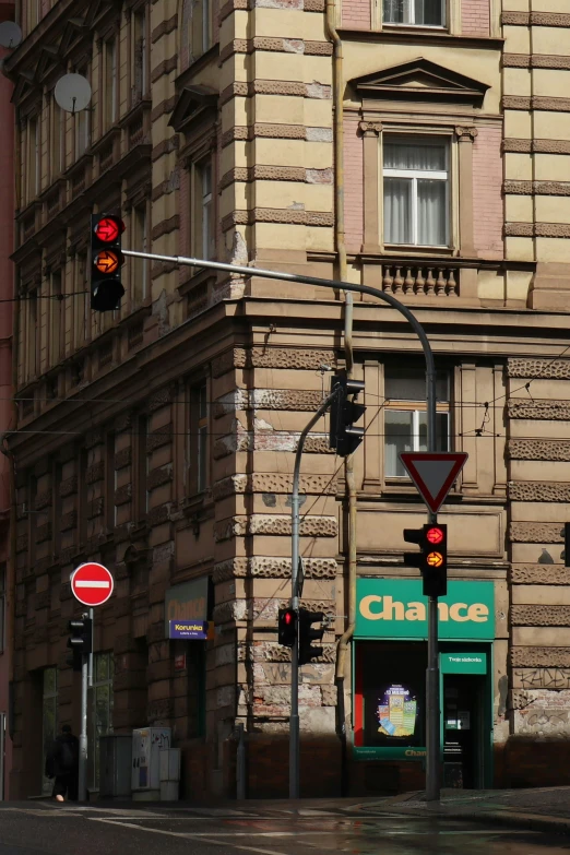 a street corner with a building and a red traffic light