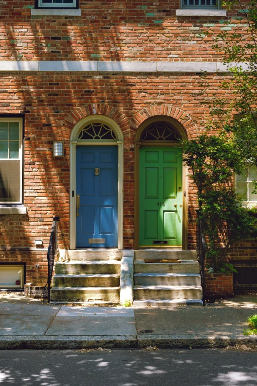 green and blue front door on a red brick house