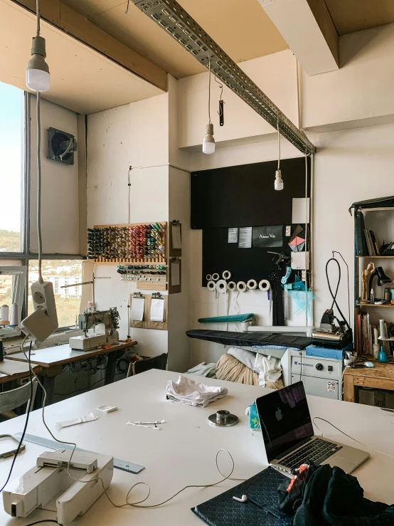 an office with a large white desk and two windows