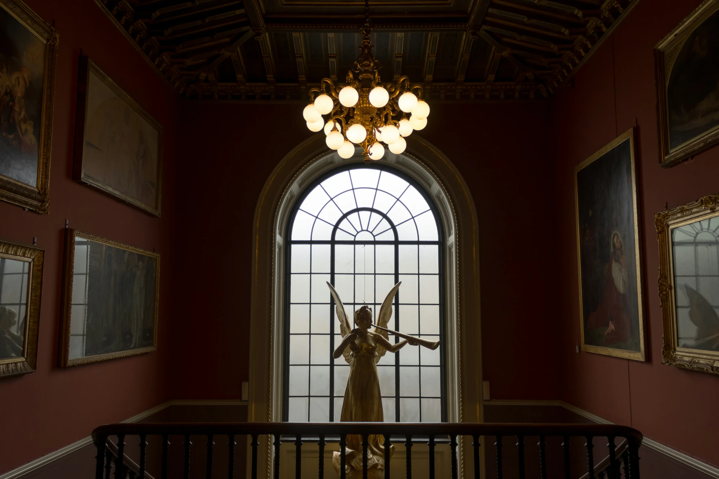 statue of woman with arms outstretched in room